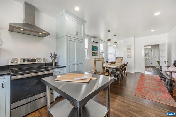 a kitchen with kitchen island a stove and a sink