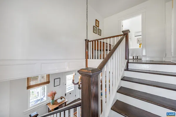 a bedroom with a large bed and wooden floor