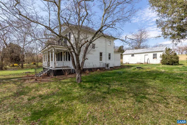 a view of a yard with a house in the background