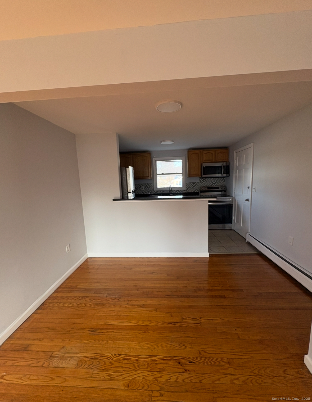 554 Eastern Street, Unit 3 New Haven, CT 06513 - Photo 2 of 5 a view of a kitchen with wooden floor and a sink