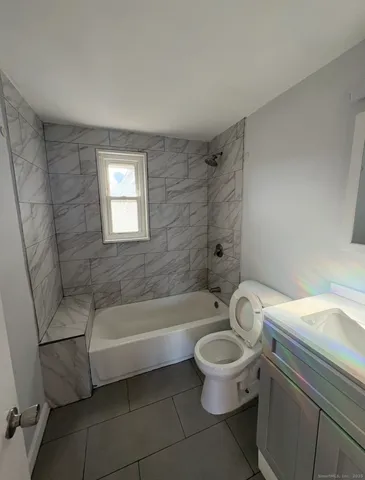 a bathroom with a toilet a sink and bathtub