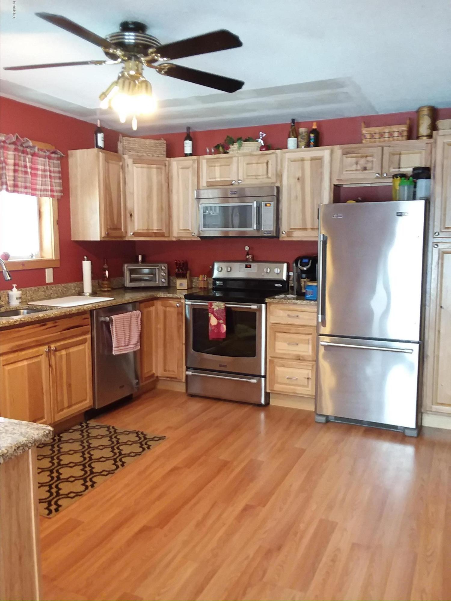 25 Kreutzer Road Peru, MA 01235 - Photo 2 of 10 a kitchen with stainless steel appliances a stove a sink and a refrigerator