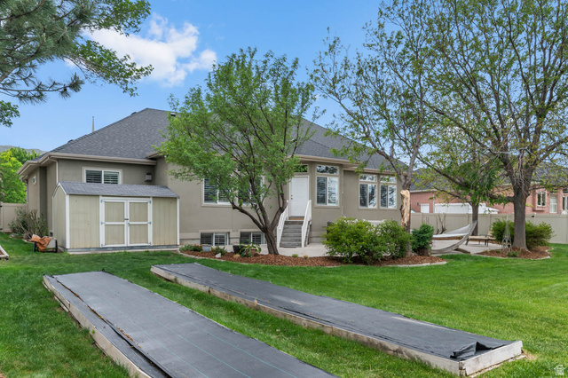439 East 13540 South Draper, UT 84020 - Photo 41 of 46 Expansive backyard featuring a manicured lawn, established trees, and a concrete patio