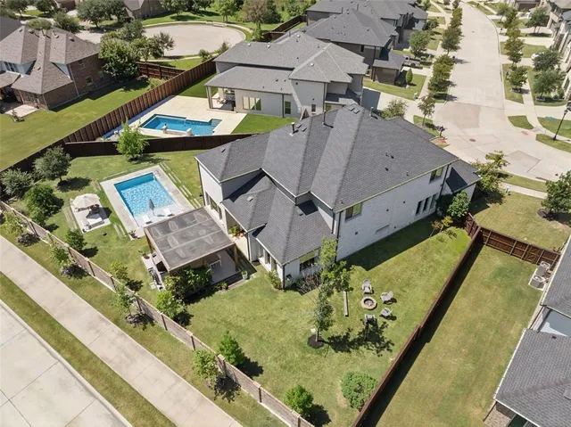 an aerial view of a house with a swimming pool