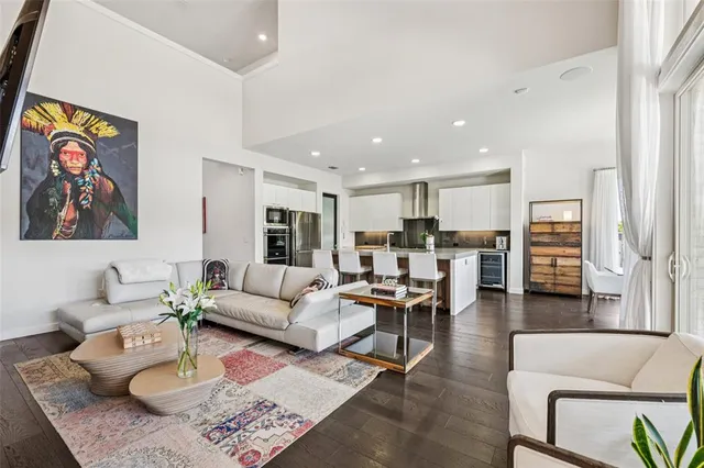 a kitchen with white cabinets stove and chairs