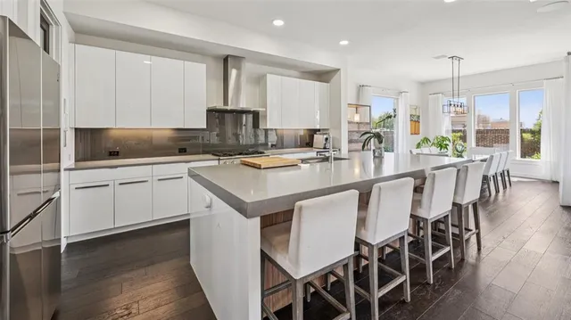 a kitchen with stainless steel appliances kitchen island granite countertop a sink and cabinets