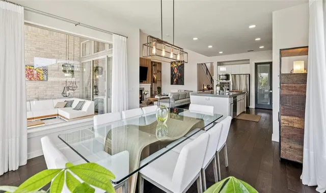 a bedroom with a bed and a large window with wooden floor