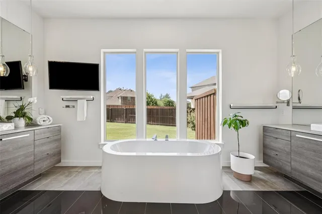 a bathroom with a tub a sink and mirrors