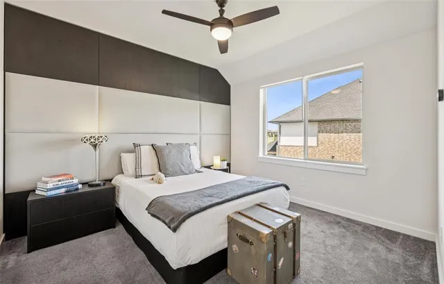 a bedroom with a bed and a flat tv screen