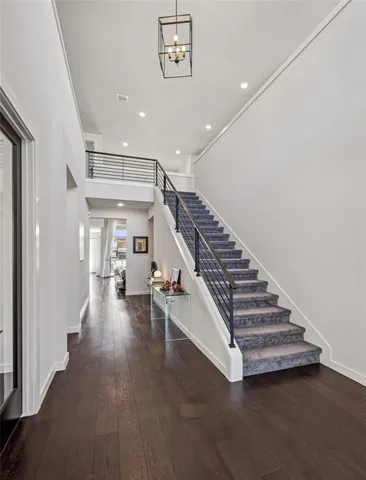 a living room with furniture a flat screen tv and a large window