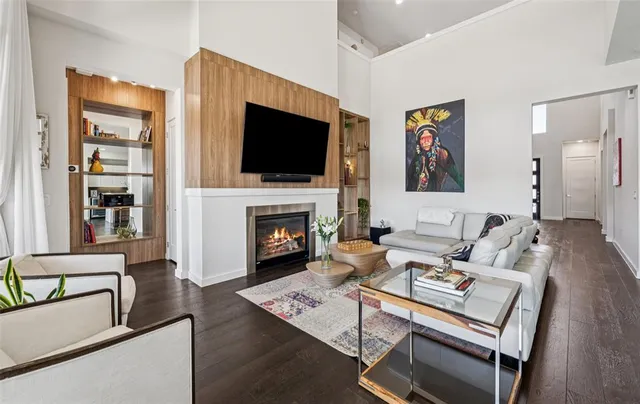 a living room with fireplace furniture and a flat screen tv