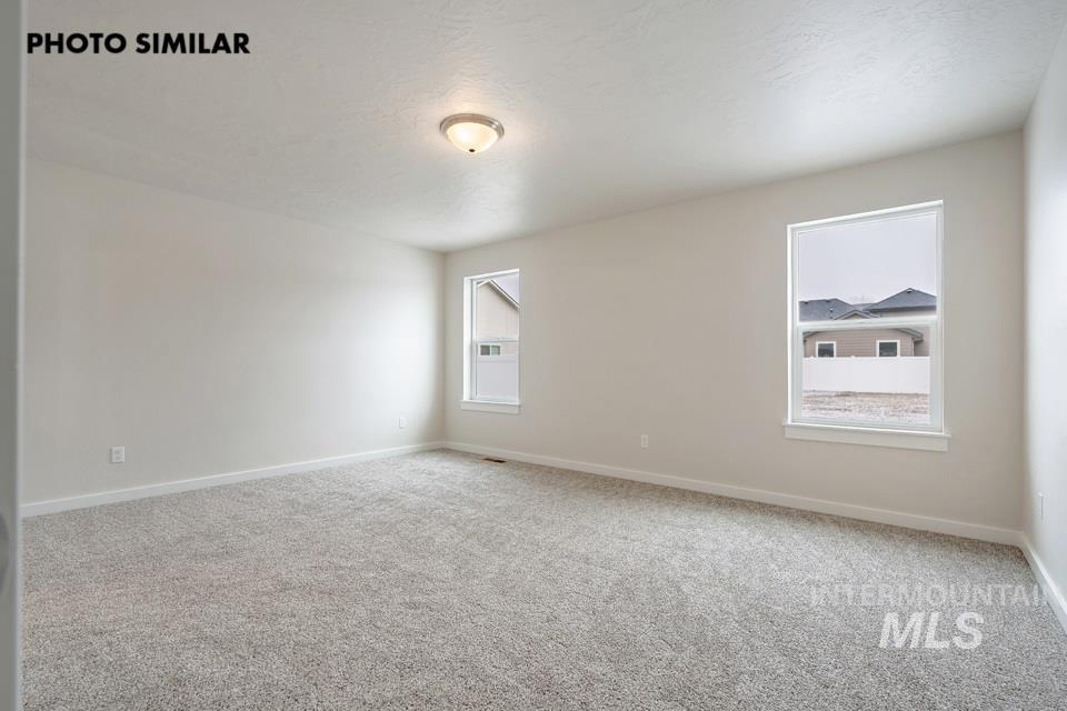 1645 Haystack Emmett, ID 83617 - Photo 15 of 33 Spacious interior room featuring light gray walls, plush gray carpeting, white trim, and two windows