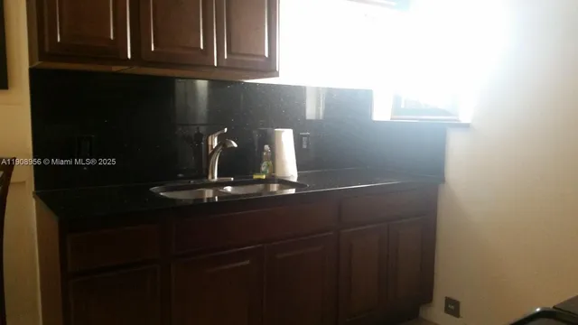 a bathroom with a toilet a sink and a window