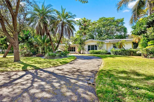 a view of house with swimming pool and green space