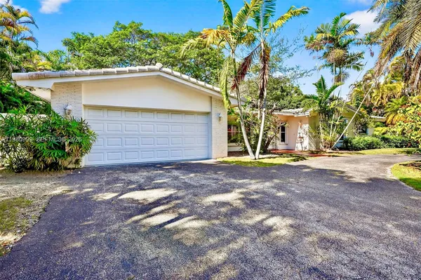 a house with a tree in front of it