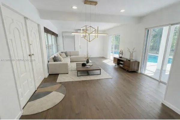 a living room with furniture and a chandelier