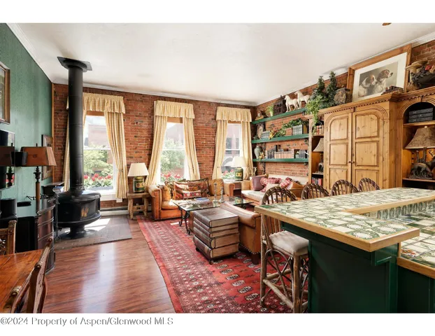 a living room with furniture and large windows