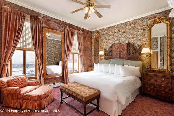 a bedroom with a bed and glass window