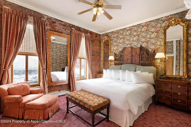 a bedroom with a bed and glass window