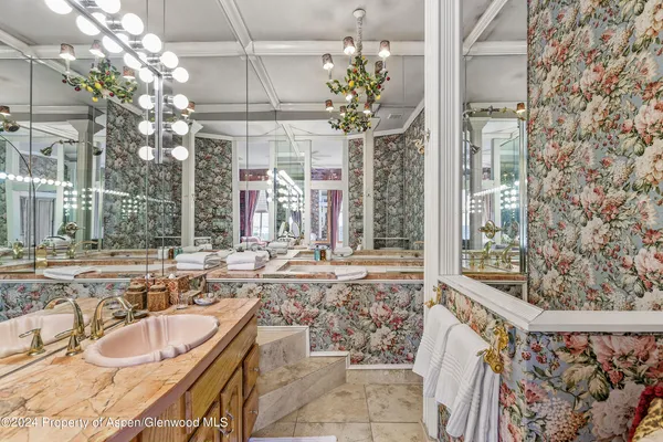 a bathroom with a tub sink and mirror