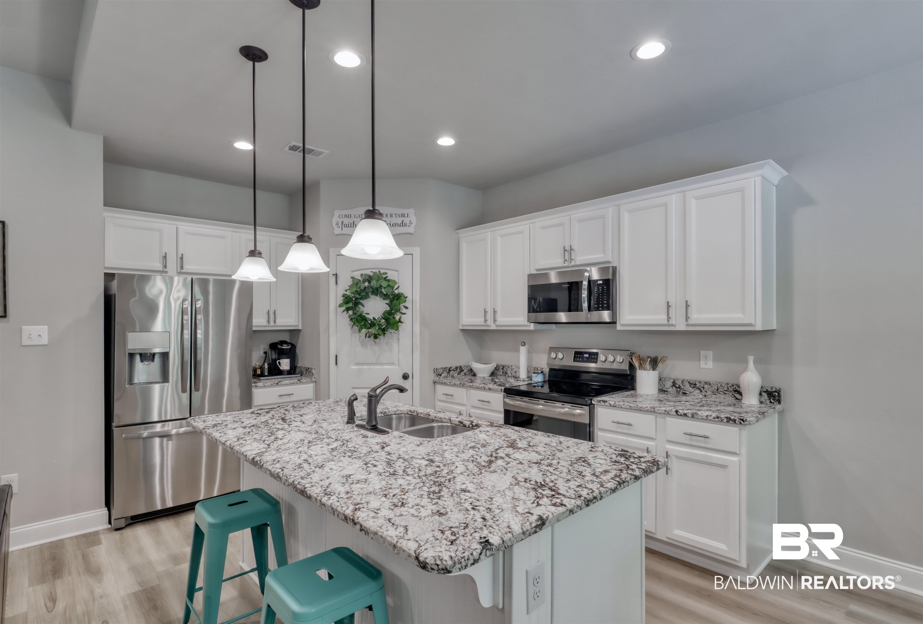 987 Gibson Court Foley, AL 36535 - Photo 13 of 34 Kitchen featuring white cabinetry, appliances with stainless steel finishes, a sink, and light wood-style flooring