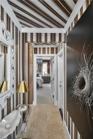 a view of a hallway with entryway and furniture