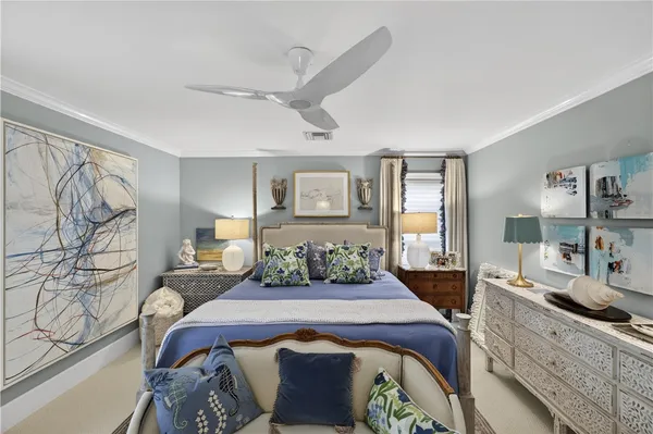 a bedroom with a large bed and a chandelier