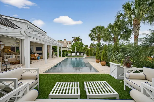 a view of a patio with couches table and chairs and potted plants