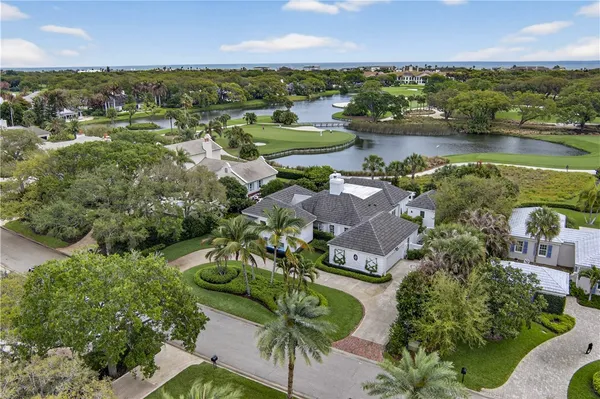 an aerial view of lake residential house with outdoor space and trees all around