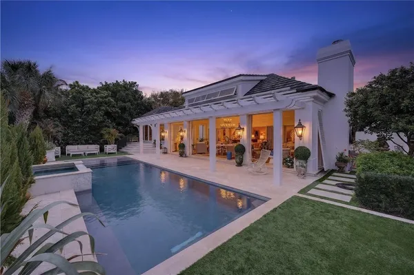 swimming pool view with a seating space and garden
