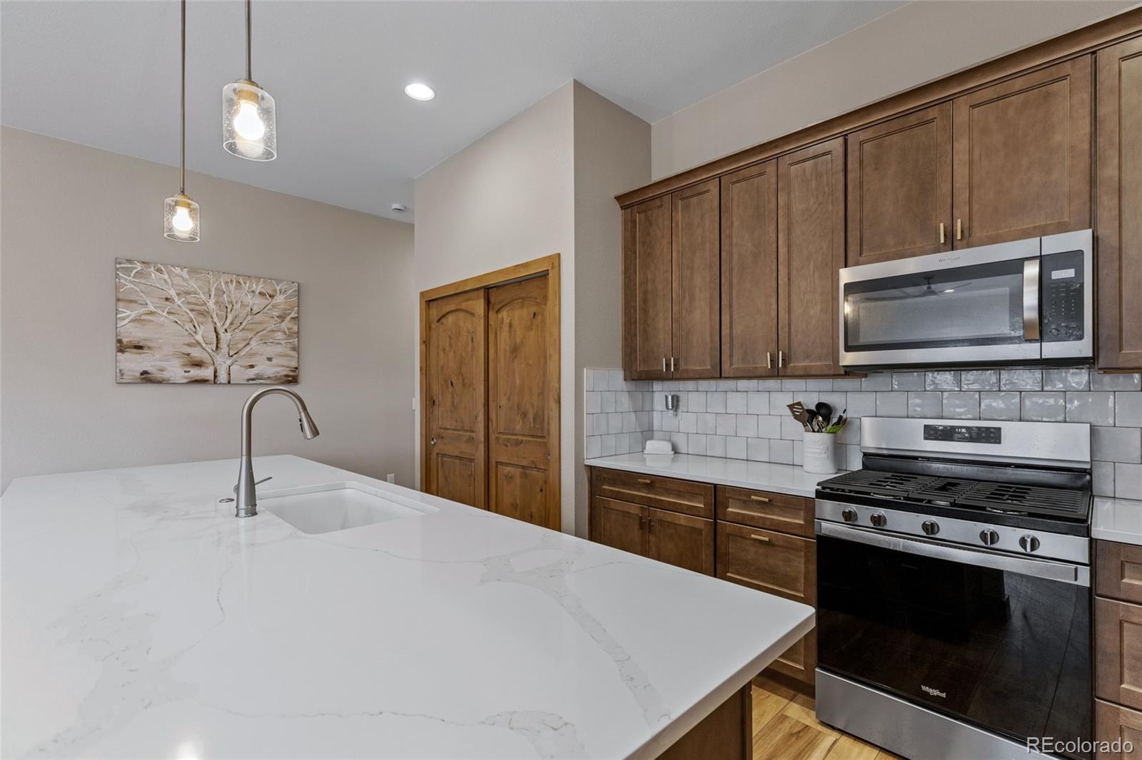 903 Liptrap Street Simla, CO 80835 - Photo 11 of 37 a kitchen with stainless steel appliances a stove microwave and sink
