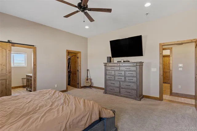 a bedroom with bed and flat screen tv