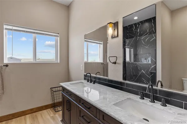 a bathroom with a granite countertop sink and a mirror