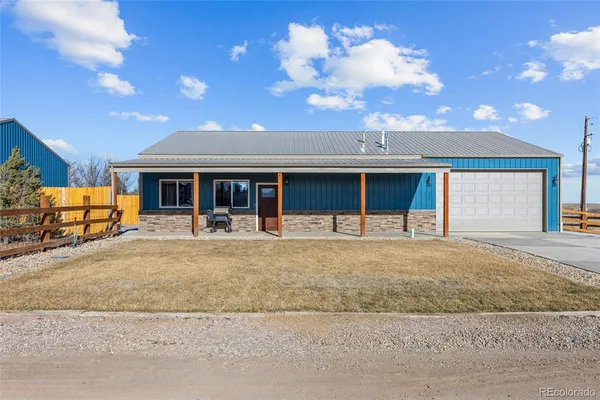 a view of a house with a swimming pool and a yard