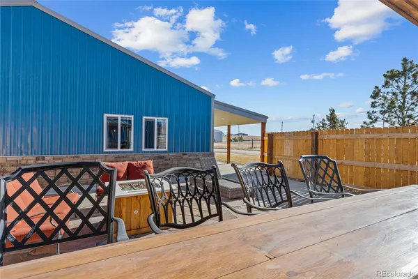 a view of a chairs and table in patio