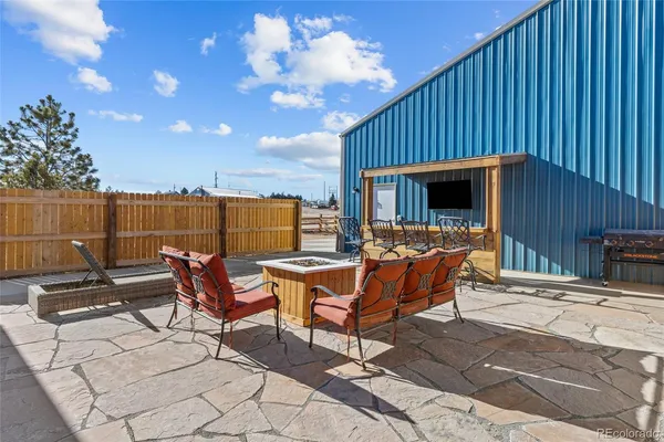 a roof deck with table and chairs