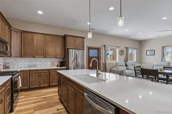 a large kitchen with kitchen island a sink stainless steel appliances and cabinets