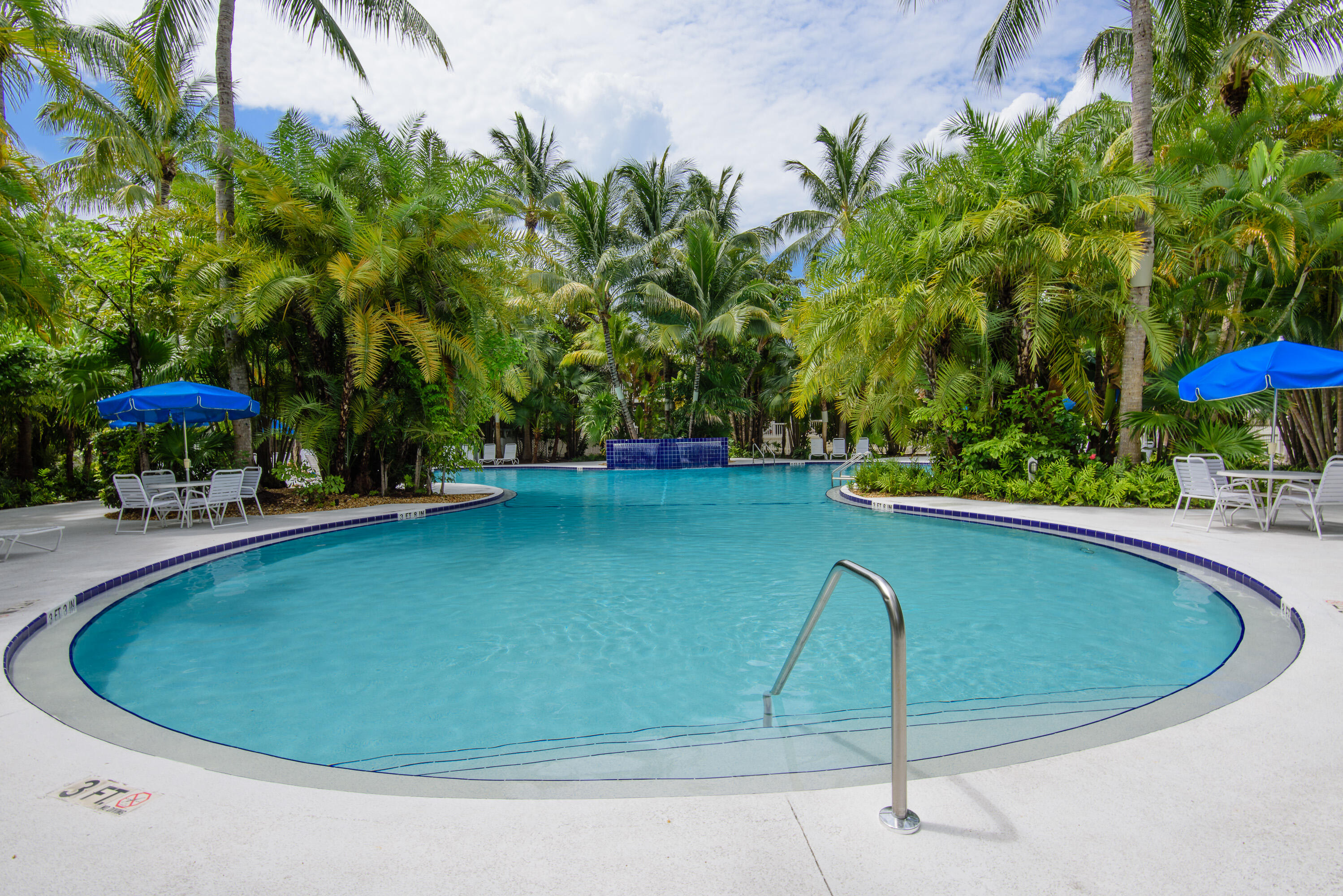 263 Golf Club Drive Key West, FL 33040 - Photo 28 of 30 a view of a swimming pool with a yard and sitting area