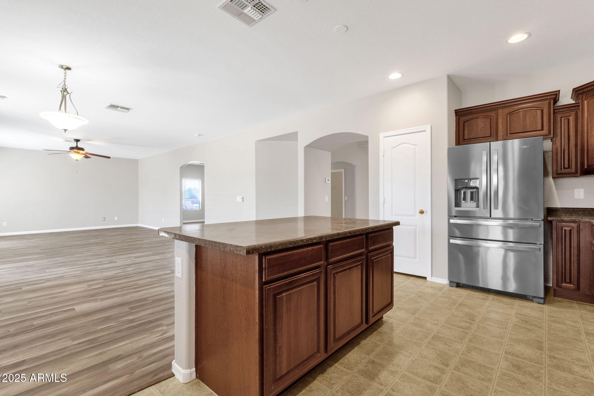 43003 West Magnolia Road Maricopa, AZ 85138 - Photo 17 of 32 a kitchen with stainless steel appliances a refrigerator and a stove