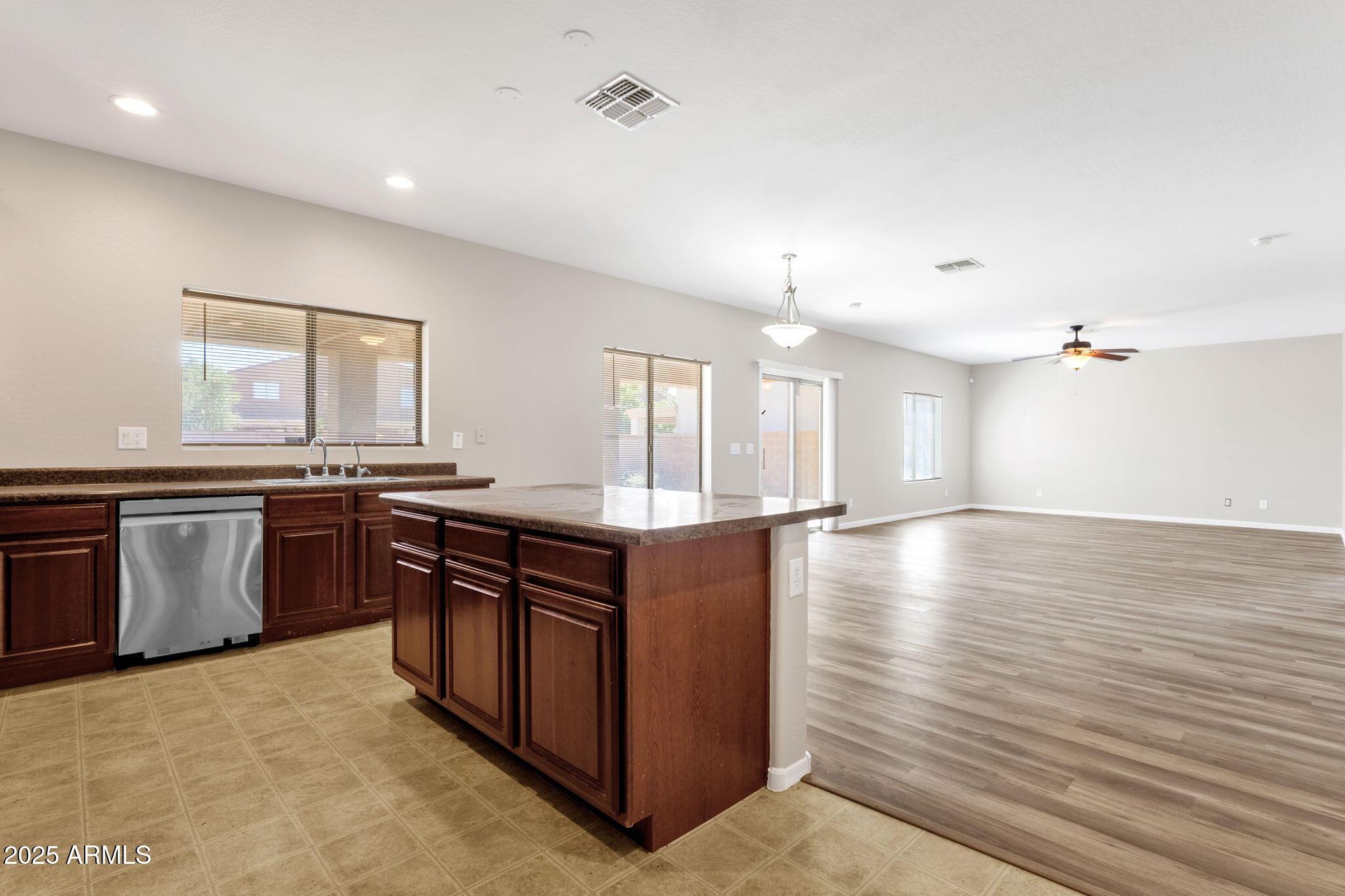 43003 West Magnolia Road Maricopa, AZ 85138 - Photo 18 of 32 a kitchen with stainless steel appliances granite countertop a stove and a sink