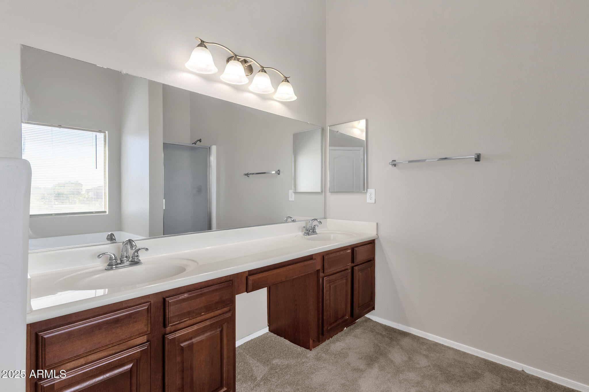 43003 West Magnolia Road Maricopa, AZ 85138 - Photo 22 of 32 a bathroom with a double vanity sink and a mirror