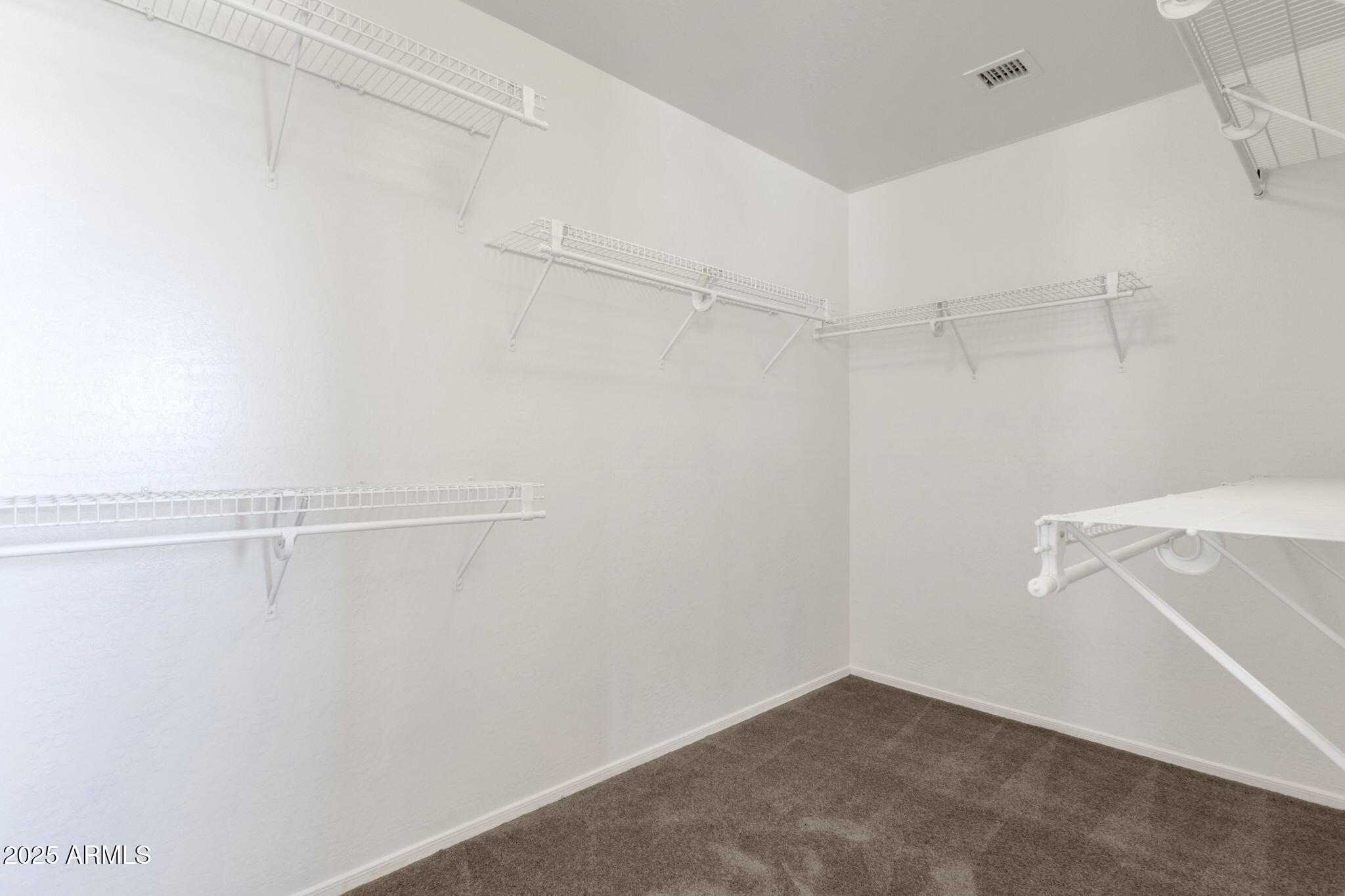 43003 West Magnolia Road Maricopa, AZ 85138 - Photo 24 of 32 a view of a room with racks on the wall