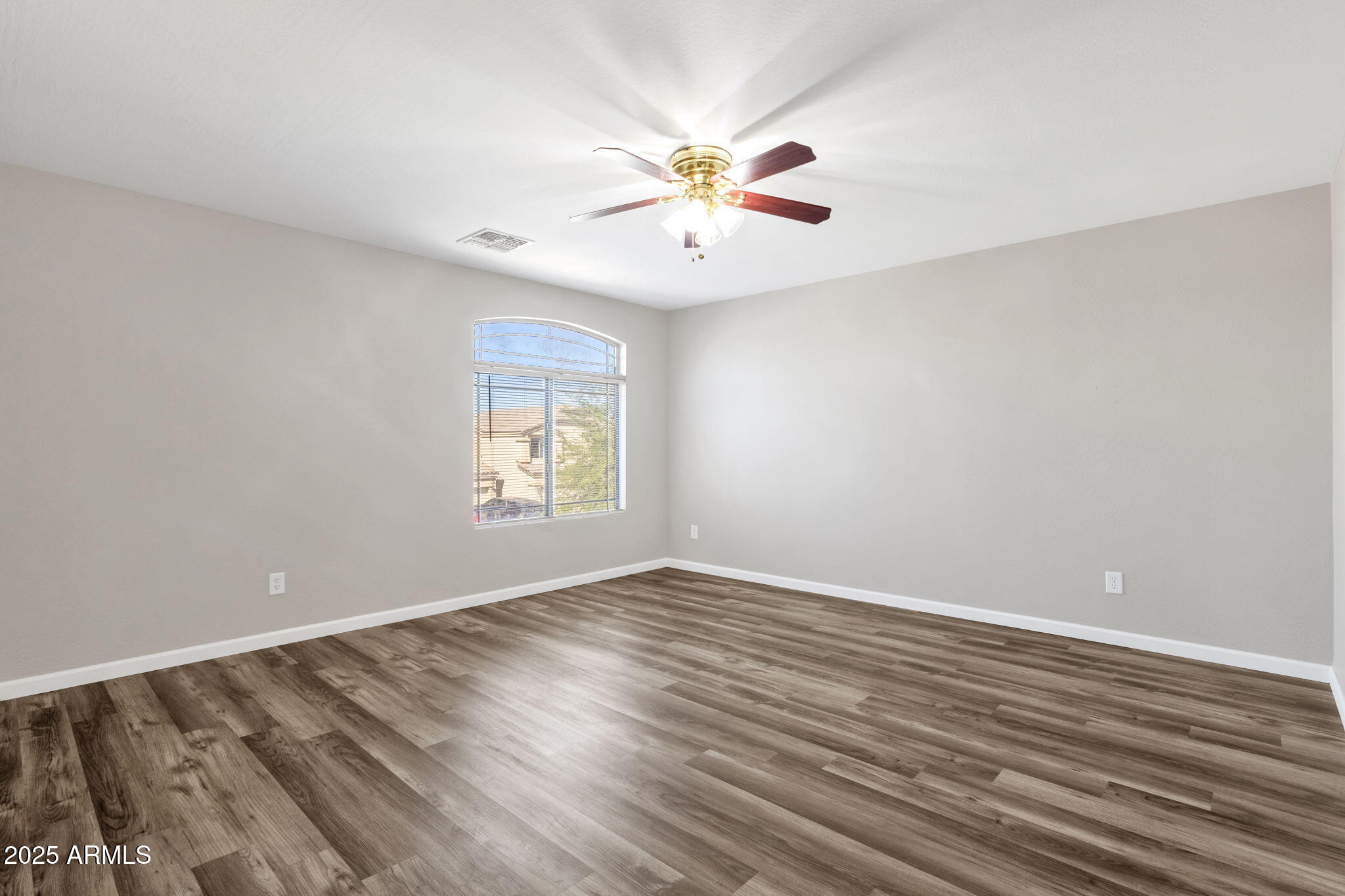 43003 West Magnolia Road Maricopa, AZ 85138 - Photo 25 of 32 wooden floor in an empty room with a window