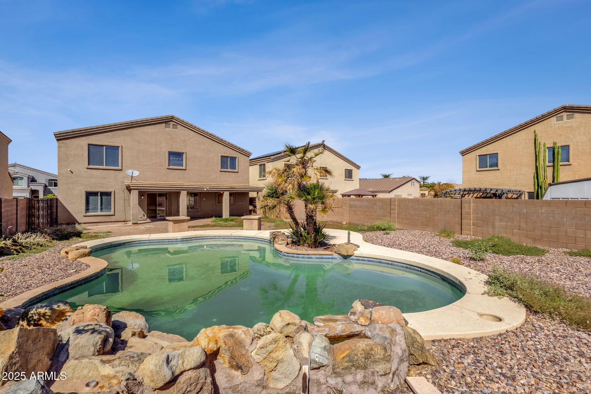 43003 West Magnolia Road Maricopa, AZ 85138 - Photo 29 of 32 a view of a house with swimming pool and a yard