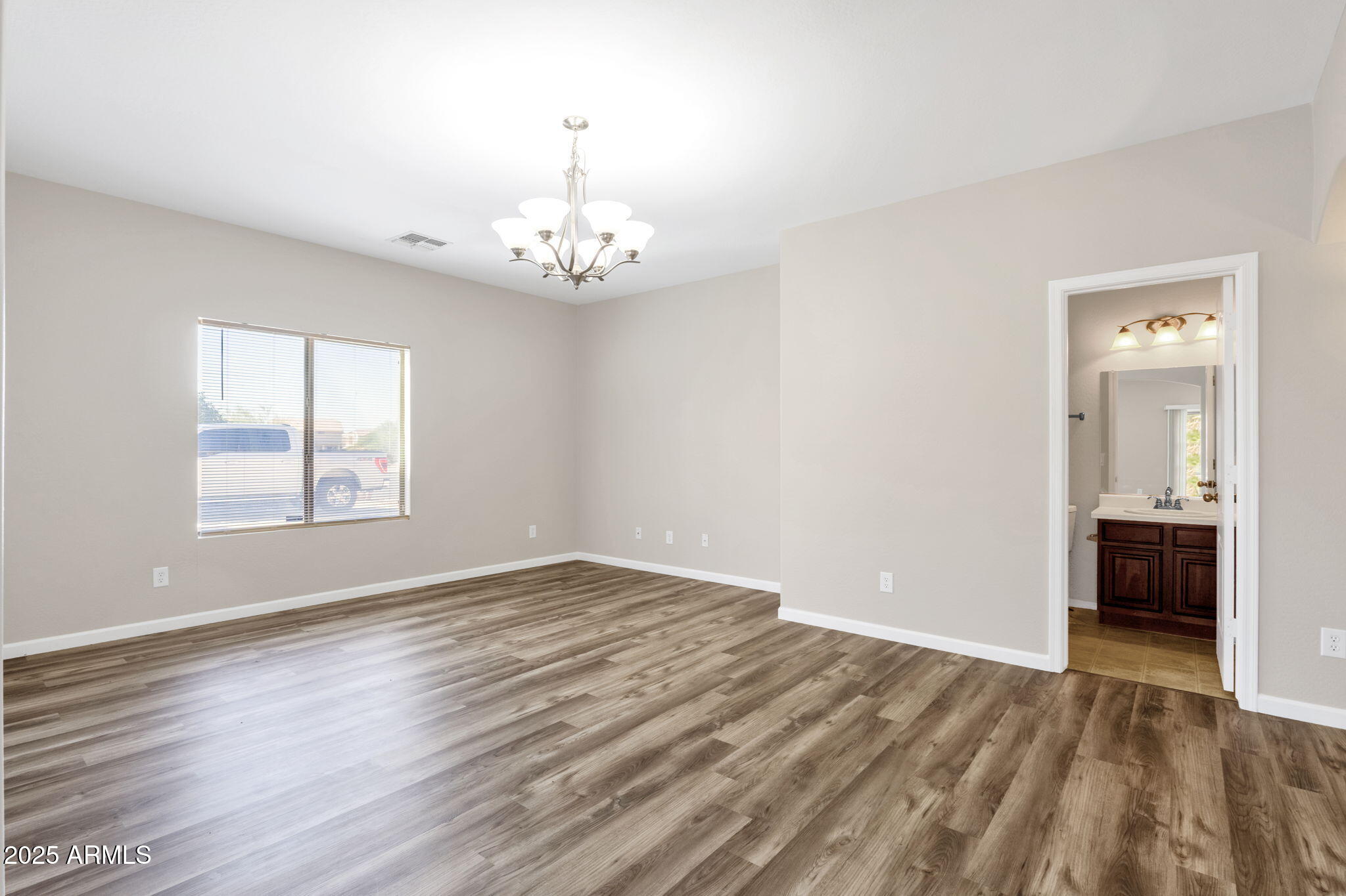 43003 West Magnolia Road Maricopa, AZ 85138 - Photo 8 of 32 wooden floor in an empty room with a window