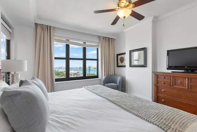 a bedroom with a bed and a painting on the wall