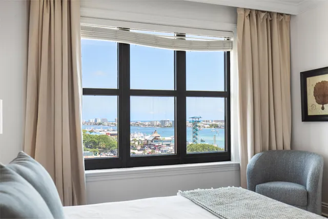 a bedroom with a large bed and a large window