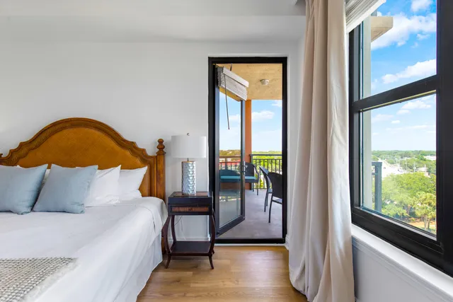 a view of a balcony with furniture and front door