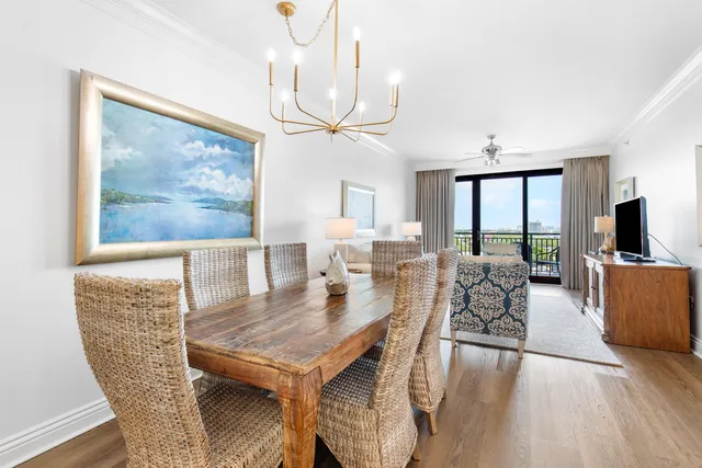 a living room with furniture a flat screen tv and a large window