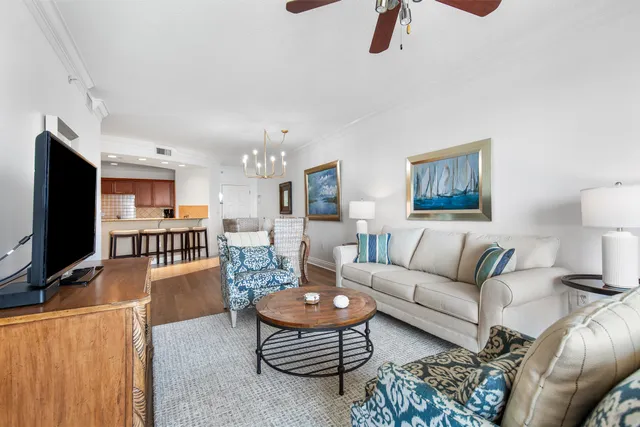 a view of a dining room with furniture a chandelier and wooden floor